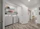 Spacious laundry room with modern washer and dryer, ample storage, and access to additional rooms at 928 Sycamore Ave, Charleston, SC 29407