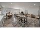 Open-concept living room featuring a dining area, bar seating, modern furnishings, and sliding glass doors to the backyard at 928 Sycamore Ave, Charleston, SC 29407