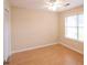 Bedroom with light beige walls, wooden floors, ceiling fan and large window at 9630 N Cardinal Dr, Ladson, SC 29456