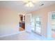 Open dining area with tile flooring, leading to the kitchen and overlooking the outdoor deck at 9630 N Cardinal Dr, Ladson, SC 29456