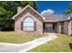Charming brick home with a well-manicured lawn and inviting walkway leading to the front door at 9630 N Cardinal Dr, Ladson, SC 29456