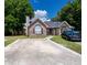 A beautiful brick home featuring a spacious driveway and tasteful landscaping for curb appeal at 9630 N Cardinal Dr, Ladson, SC 29456