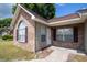 Close up view of a charming brick home with tan vinyl siding and a well-kept lawn at 9630 N Cardinal Dr, Ladson, SC 29456