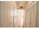 Hallway with light beige walls, wooden floors, closet and view to the living room at 9630 N Cardinal Dr, Ladson, SC 29456
