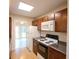 Functional kitchen with dark cabinets and appliances, adjacent to a sunny breakfast nook at 9630 N Cardinal Dr, Ladson, SC 29456