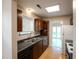 Well-lit kitchen with stainless steel sink and dark cabinetry, showcasing a clean and functional space at 9630 N Cardinal Dr, Ladson, SC 29456