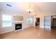 Spacious living room featuring a fireplace, modern lighting, and seamlessly connected to the kitchen at 9630 N Cardinal Dr, Ladson, SC 29456