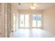 Bright sunroom with white tile floors and multiple glass doors, perfect for enjoying natural light at 9630 N Cardinal Dr, Ladson, SC 29456