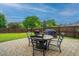 Brick patio with outdoor dining set and grill in a fenced backyard with lush lawn at 9636 Pebble Creek Blvd, Summerville, SC 29485