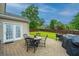 Backyard patio with a table and chairs, outdoor grill, and a well-maintained grassy area at 9636 Pebble Creek Blvd, Summerville, SC 29485