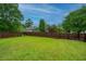 Large backyard with a well-maintained lawn and privacy fence, offering ample space for outdoor activities at 9636 Pebble Creek Blvd, Summerville, SC 29485