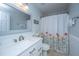Bathroom with a modern vanity, decorative mirror, and shower/tub combo with a floral shower curtain at 9636 Pebble Creek Blvd, Summerville, SC 29485