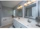 Bright bathroom features a double vanity, soaking tub, and ample lighting, perfect for relaxation at 9636 Pebble Creek Blvd, Summerville, SC 29485