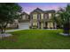 Charming two-story home featuring a well-manicured lawn and a classic architectural design at 9636 Pebble Creek Blvd, Summerville, SC 29485