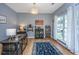 Stylish home office with hardwood floors, a large window, and a custom bar area at 9636 Pebble Creek Blvd, Summerville, SC 29485