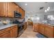Well-equipped kitchen with stainless steel appliances, granite countertops, and wood cabinetry at 9636 Pebble Creek Blvd, Summerville, SC 29485