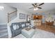 Open-concept living room with stairs leading to a second level and easy access to the kitchen and dining area at 9636 Pebble Creek Blvd, Summerville, SC 29485