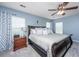 Relaxing main bedroom features a ceiling fan, soft lighting, and a cozy bed, providing comfort at 9636 Pebble Creek Blvd, Summerville, SC 29485