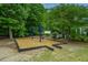 A neighborhood playground features a swing set with a wood chip safety ground cover and mature shade trees at 9636 Pebble Creek Blvd, Summerville, SC 29485