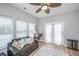 Inviting sunroom with French doors, natural light, and cozy seating creates a serene atmosphere at 9636 Pebble Creek Blvd, Summerville, SC 29485
