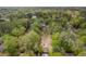 Spacious wooded lot featuring mature trees and a home with a red roof at 9666 Jamison Rd, Ladson, SC 29456