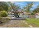 Charming home featuring a pergola-covered deck and beautifully landscaped backyard with stepping stones at 9666 Jamison Rd, Ladson, SC 29456