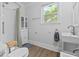 Clean bathroom showcasing walk-in shower, window, and white storage cabinet at 9666 Jamison Rd, Ladson, SC 29456