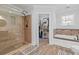 Full bathroom with a glass-enclosed shower, a soaking tub, and a walk-in closet with lots of storage space at 9666 Jamison Rd, Ladson, SC 29456