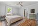 Relaxing bedroom with a large bed, natural light, hardwood floors, and neutral decor at 9666 Jamison Rd, Ladson, SC 29456