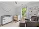 Charming Bedroom with gray rocking chair, crib, changing table, and natural light at 9666 Jamison Rd, Ladson, SC 29456