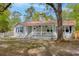 Charming exterior view of home showcasing a white picket fence and a cozy front porch at 9666 Jamison Rd, Ladson, SC 29456