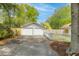 Detached two-car garage with white doors and ample parking space at 9666 Jamison Rd, Ladson, SC 29456