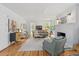 Cozy living room with hardwood floors, a brick fireplace, and lots of natural light at 9666 Jamison Rd, Ladson, SC 29456