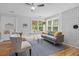 Cozy living room with gray sofa, white brick wall, and lots of natural light at 9666 Jamison Rd, Ladson, SC 29456