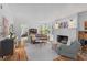 Open living room featuring hardwood floors, white ceiling, and a cozy brick fireplace at 9666 Jamison Rd, Ladson, SC 29456