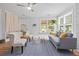Comfortable living room with bright, natural light featuring hardwood floors, a ceiling fan, and modern furnishings at 9666 Jamison Rd, Ladson, SC 29456