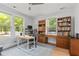 Bright home office with natural light, hardwood floors, custom desk and a comfortable work setting at 9666 Jamison Rd, Ladson, SC 29456