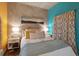Bright bedroom featuring a concrete accent wall, soft lighting, and stylish decor at 1 Cool Blow St # 344, Charleston, SC 29403