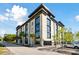 Contemporary building with large windows, palm trees, and a gated entrance on a sunny day at 1 Cool Blow St # 344, Charleston, SC 29403