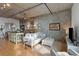 View of a modern living area with concrete walls and open access to the kitchen at 1 Cool Blow St # 344, Charleston, SC 29403