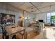 Bright living room with wood floors, concrete ceiling, open floor plan, island, and a dining area at 1 Cool Blow St # 344, Charleston, SC 29403