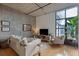 Bright living room features concrete wall and ceiling and large windows at 1 Cool Blow St # 344, Charleston, SC 29403