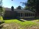 Exterior view of the house with a screened-in porch surrounded by green grass at 1010 Foxcroft Rd, Charleston, SC 29412