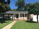Charming brick home with a green lawn, trimmed hedges and a covered front porch at 1010 Foxcroft Rd, Charleston, SC 29412