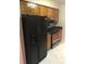 Practical kitchen with stainless steel oven, black refrigerator and wooden cabinets at 1010 Foxcroft Rd, Charleston, SC 29412