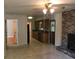 Open concept living room features a brick fireplace, hardwood floors and transitions to the kitchen at 1010 Foxcroft Rd, Charleston, SC 29412