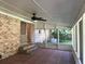 A screened-in porch features brick walls and a brick-tile floor, looking onto a backyard at 1010 Foxcroft Rd, Charleston, SC 29412