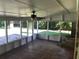 A screened-in porch overlooks a green backyard from a tile floor and screened windows at 1010 Foxcroft Rd, Charleston, SC 29412