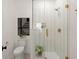 Bathroom with neutral toned tiles in the shower and floor with a modern toilet and framed picture at 1014 Alamo St, North Charleston, SC 29405