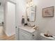 Bright and airy bathroom with a white vanity, marble countertop, and gold fixtures at 1014 Alamo St, North Charleston, SC 29405